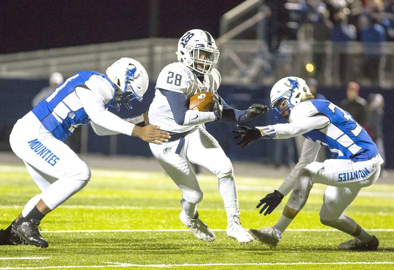 Special to NWA Democrat-Gazette/DAVID BEACH Bentonville West running back Tyrese Smallwood (28) tries to slip between Rogers High defenders A-ron Jones (21) and Jacob Taylor on Friday at Whitey Smith Stadiium in Rogers.