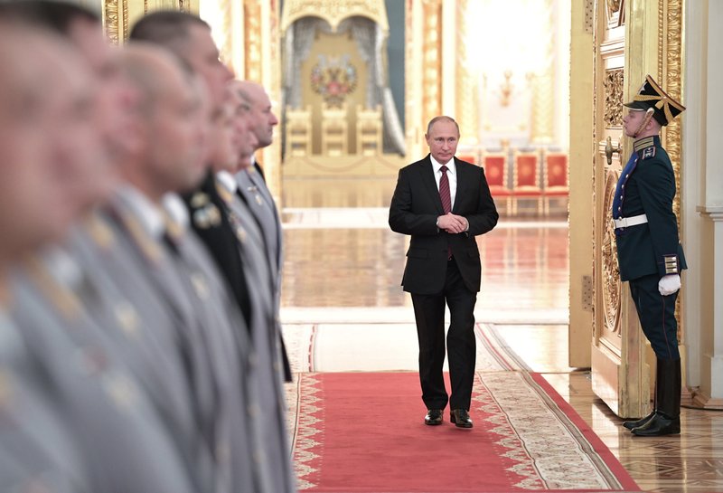 Russian President Vladimir Putin, center, walks in a hall during a meeting with senior military officers in the Kremlin in Moscow, Russia, Thursday, Oct. 26, 2017. 