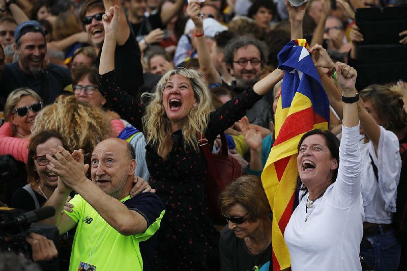 Pro-secession demonstrators celebrate Friday in Barcelona, watching on a big-screen television as Catalonia’s parliament votes to unilaterally declare independence from Spain.