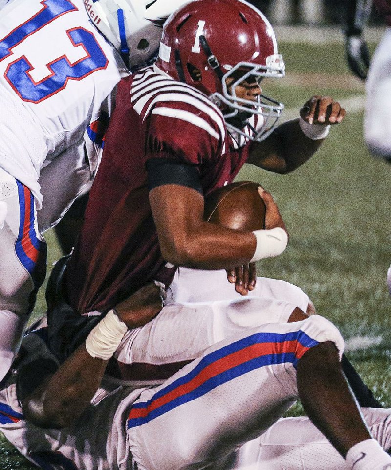 West Memphis quarterback Tyler Foots (1) gets sacked by Pine Bluff defensive end Verndarius Hodges on Friday in Pine Bluff. The Zebras defeated the Blue Devils 33-7.