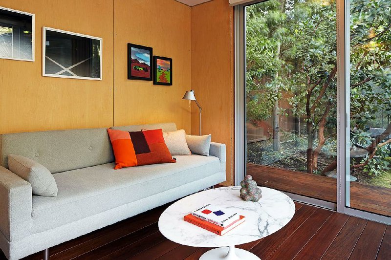 Chelsea Hadley’s unit has a sofa, a sliding-glass door and artwork on the walls.