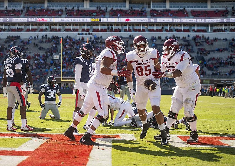 Hawgs Illustrated/BEN GOFF 
Colton Jackson (from left), Arkansas tackle, Cheyenne O'Grady (85), Arkansas tight end, and Johnny Gibson, Arkansas tackle, celebrate after O'Grady scored a touchdown in the third quarter against Ole Miss Saturday, Oct. 28, 2017, at Vaught-Hemingway Stadium in Oxford, Miss. 