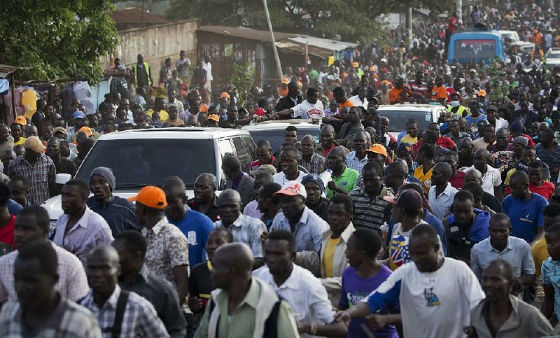 Opposition supporters surround the motorcade of their leader, Raila Odinga, as it moves Friday through the Kibera slum in Nairobi, Kenya.