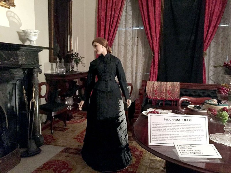 A figure in black strikes a moody pose in the Merchant’s House Museum in New York. The house — once home to the Tredwell family, seven of whom died there — now hosts ghost tours.
