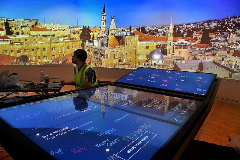 Senior software developer Donnie Richardson is still doing testing at the area where visitors to the Museum of the Bible can write on a large interactive tablet table. Those messages will be shown on the big screen in the background (now featuring a panoramic photo of Jerusalem).