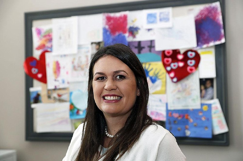 White House press secretary Sarah Huckabee Sanders poses for a photograph in front of a bulletin board with her children's artwork in her office in the West Wing of the White House, Thursday, Sept. 14, 2017, in Washington. (AP Photo/Alex Brandon)