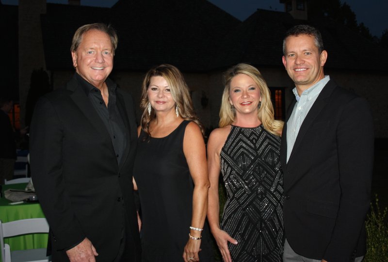 NWA Democrat-Gazette/CARIN SCHOPPMEYER Cameron and Monica Smith, Nox Stelatta honorary chairmen (from left), and Brandy and John Furner, honorary hosts, welcome guests to the Youth Bridge fundraiser Oct. 19 in Rogers.