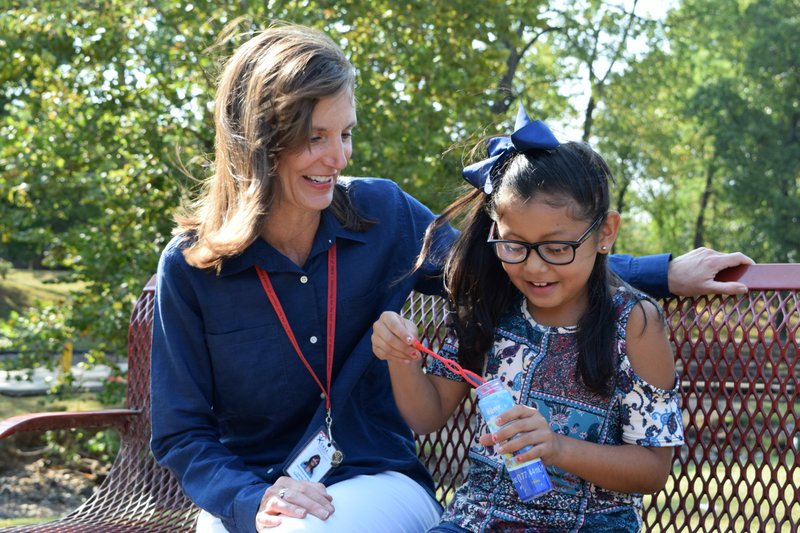 Courtesy photo Lori Wood (from left), who has been a CASA Advocate for four years, sits with Alyssa Sanchez, daughter of a fellow advocate.