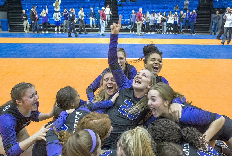 Fayetteville players celebrate Saturday after claiming their third consecutive Class 7A state volleyball championship at Bank of Ozarks Arena in Hot Springs.