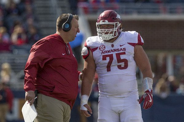 Bret Bielema, Arkansas head coach, talks with center Zach Rogers in the second quarter against Ole Miss Saturday, Oct. 28, 2017, at Vaught-Hemingway Stadium in Oxford, Miss. 
