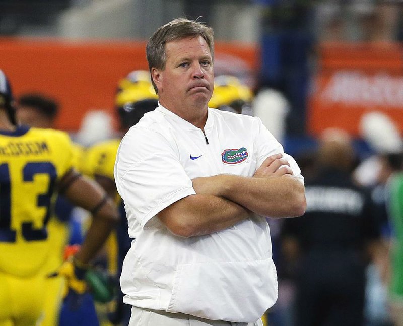 This is a Sept. 2, 2017, file photo showing Jim McElwain watching his team warm up before an NCAA college football game against Michigan, in Arlington, Texas. 