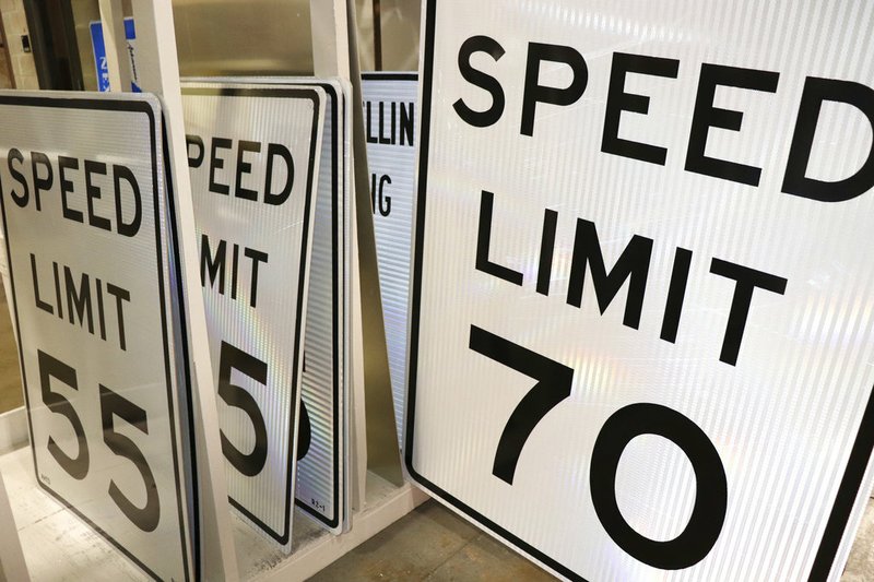 In this photo taken Aug. 1, 2017, a 70 mph speed limit sign sits near others in a storage area at an Arkansas Department of Transportation depot in Little Rock.