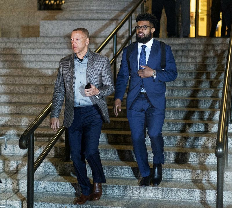 Dallas Cowboys star Ezekiel Elliott, right, exits federal court after a hearing Monday, Oct. 30, 2017 in New York. Elliott is seeking to have his six game suspension by the NFL postponed. 