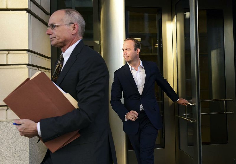 Rick Gates (right) leaves federal court in Washington on Monday. Gates is a former business associate of Paul Manafort, the former chairman of Donald Trump’s presidential campaign who also pleaded innocent Monday to felony charges of conspiracy against the United States.