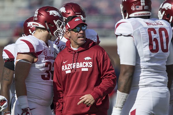 Arkansas offensive coordinator Dan Enos talks to players prior to a game against Ole Miss on Saturday, Oct. 28, 2017, in Oxford, Miss. 