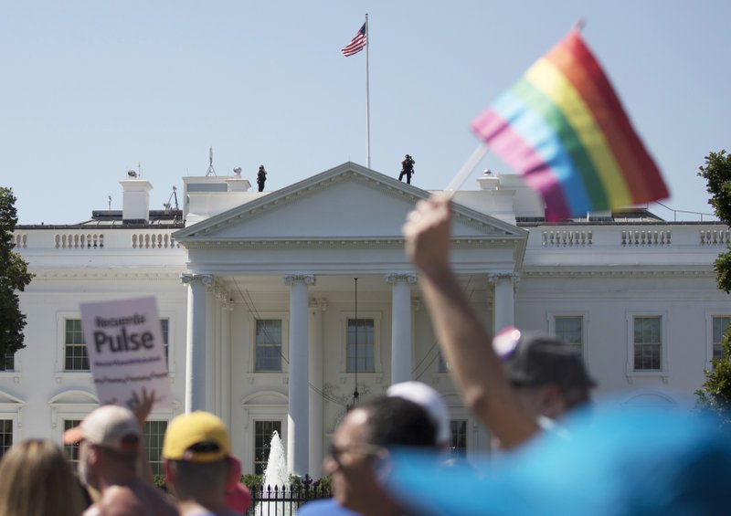 In this Sunday, June 11, 2017 file photo, Equality March for Unity and Pride participants march past the White House in Washington. 