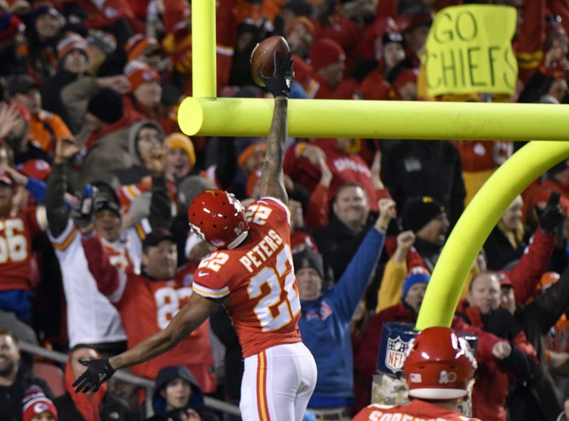 Kansas City Chiefs defensive back Marcus Peters (22) celebrates his touchdown after he stripped the ball from Denver Broncos running back Jamaal Charles (28), during the first half of an NFL football game in Kansas City, Mo., Monday, Oct. 30, 2017. Peters recovered the ball and ran for a touchdown. 