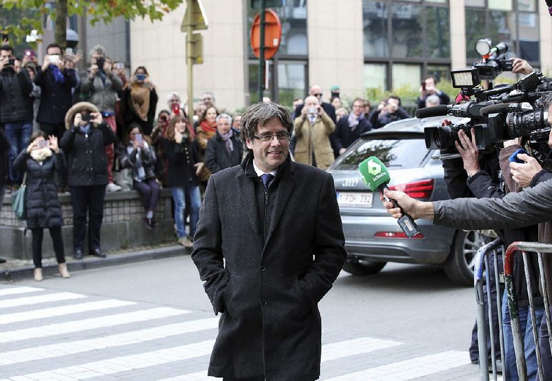 Carles Puigdemont, the ousted president of Spain’s Catalonia region, arrives Tuesday at a news conference in Brussels. Puigdemont, who in Spain faces criminal charges linked to the region’s independence effort, said he and several colleagues would return home if they were guaranteed “freedom and safety.”  
