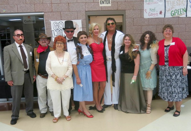 Photo by Susan Holland Murder suspects in the &quot;Who Dun It?&quot; game at the Gravette Public Library gala Oct. 7 included Groucho Marx (Merv Boyd), left, John Wayne (Larry Jones), Lucille Ball (Lois Phippen), Fred Astaire (Jay Oliphant), Judy Garland (Linda Oliphant), Marilyn Monroe (Kelly Britton), Elvis Presley (Jim Bob Britton), Ginger Rogers (Jodi Moore), Janis Joplin (Carole Robel) and Patsy Cline (Karen Benson). Ginger Rogers proved to be the culprit.