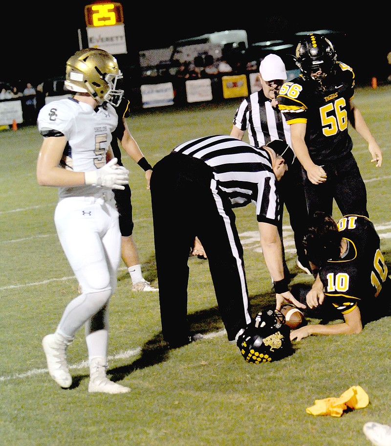 MARK HUMPHREY ENTERPRISE-LEADER An official spots the ball after Prairie Grove quarterback J.D. Elder's helmet was unlatched by a defender with players on the ground. That key win over Shiloh coupled with Friday's 34-6 triumph at Berryville secures the No. 2 seed for Prairie Grove out of the 4A-1. MARK HUMPHREY ENTERPRISE-LEADER An official spots the ball after Prairie Grove quarterback J.D. Elder's helmet was unlatched by a defender with players on the ground. That key win over Shiloh coupled with Friday's 34-6 triumph at Berryville secures the No. 2 seed for Prairie Grove out of the 4A-1.