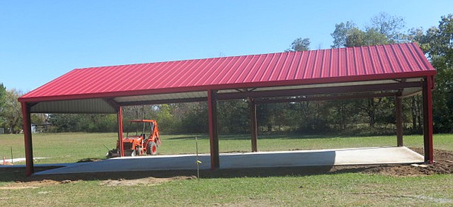 Photo by Susan Holland A spacious pavilion with a red metal roof, concrete floor and adjoining sidewalks was recently completed on the grounds of the Hiwasse Community Center. Gravette City Council members, at their meeting Oct. 26, accepted a bid from Electrical Resources for remodeling work on the Community Center building. Outdoor restrooms are being built and playground equipment will be installed soon.