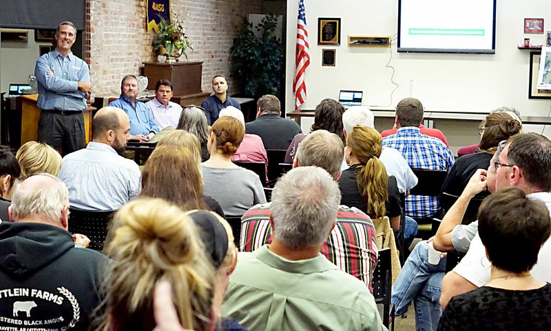 Photo by Randy Moll David Jackson, along with James Smith, Russell Tooley and Donny Epps, representing Simmons Foods, fielded questions from area residents about the new poultry processing plant being planned along Y-City Road, between Gentry and Decatur, at a Chamber of Commerce meeting held in the McKee Community Room in Gentry on Oct. 23. Numerous landowners in attendance were concerned about what the new facility would do to the value of their properties. Approximately 50 people attended the event held in the McKee Community Room at Gentry Public Library.