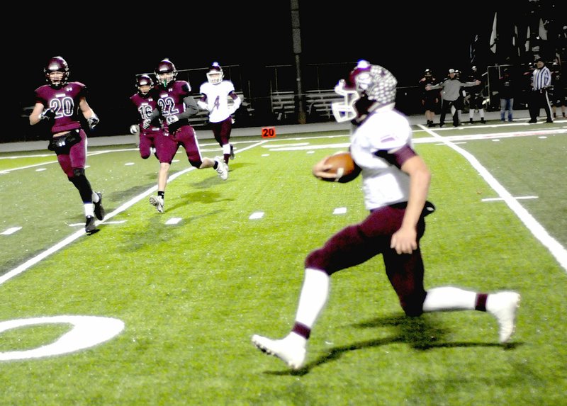 Photo by Mark Humphrey Gentry senior quarterback, Jon Faulkenberry, got loose for this long touchdown run at Lincoln. The Pioneers earned a playoff berth by beating the Wolves, 34-14, Friday.