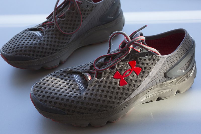 FILE - In this Monday, Jan. 4, 2016, file photo, a pair of Under Armour SpeedForm Gemini 2 Record Equipped running shoes, containing an embedded chip to track exercise, are displayed in New York.  (AP Photo/Mark Lennihan, File)