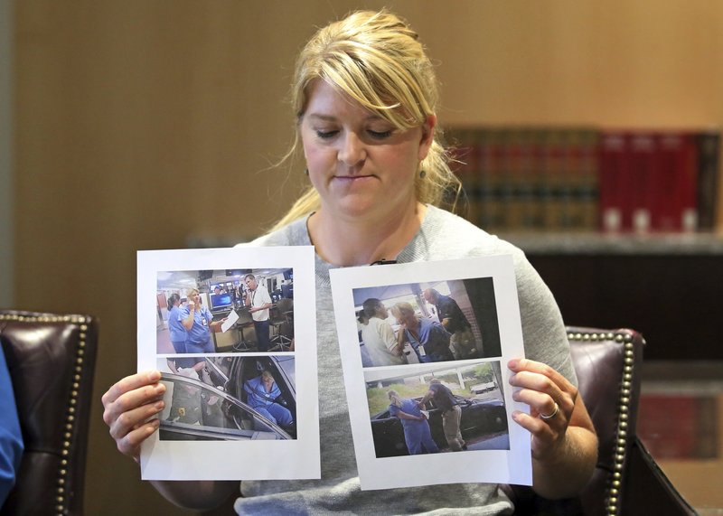 FILE - In this Friday, Sept. 1, 2017, file photo, nurse Alex Wubbels displays video frame grabs from Salt Lake City Police Department body cams of herself being taken into custody, during an interview in Salt Lake City. Wubbels, who was arrested for refusing to let a police officer draw blood from an unconscious patient said Tuesday, Oct. 31, 2017, that she was settling with Salt Lake City and the university that runs the hospital for $500,000. (AP Photo/Rick Bowmer, File)