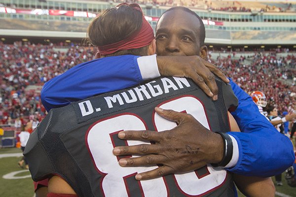 Florida associate head coach Randy Shannon hugs Arkansas receiver Drew Morgan following a game Saturday, Nov. 5, 2016, in Fayetteville. 