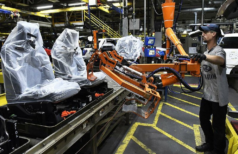 Workers assemble Ford trucks Friday at a plant in Louisville, Ky. U.S. businesses reportedly added more jobs in October than expected. 