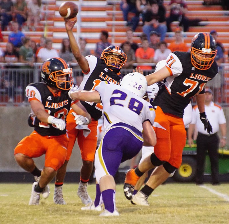 Photo by Randy Moll
Gravette quarterback Tajae White delivers a pass as Booneville's Grant Rodatz provides pressure during a Sept. 8 game at Lion Stadium in Gravette. Gravette can clinch a home playoff berth with a win Friday at Gentry.