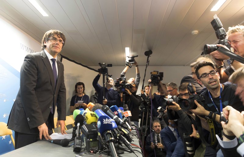 Sacked Catalonian President Carles Puigdemont looks on after a press conference in Brussels, Tuesday, Oct. 31, 2017. Ousted Catalan President Carles Puigdemont is calling for avoiding violence and says dialogue is a priority during his first address on Belgian soil. Puigdemont on Tuesday recapped the issues which led him to leave for Belgium the previous day, but did not immediately say in his statement what he would do in Brussels or whether he would seek asylum. (AP Photo/Olivier Matthys)