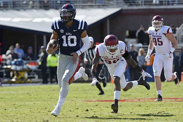 Ole Miss quarterback Jordan Ta'amu (10) runs past Arkansas defensive back Kevin Richardson II (30) for a 49-yard touchdown during the first half of an NCAA college football game in Oxford, Miss., Saturday, Oct. 28, 2017. (AP Photo/Thomas Graning)

