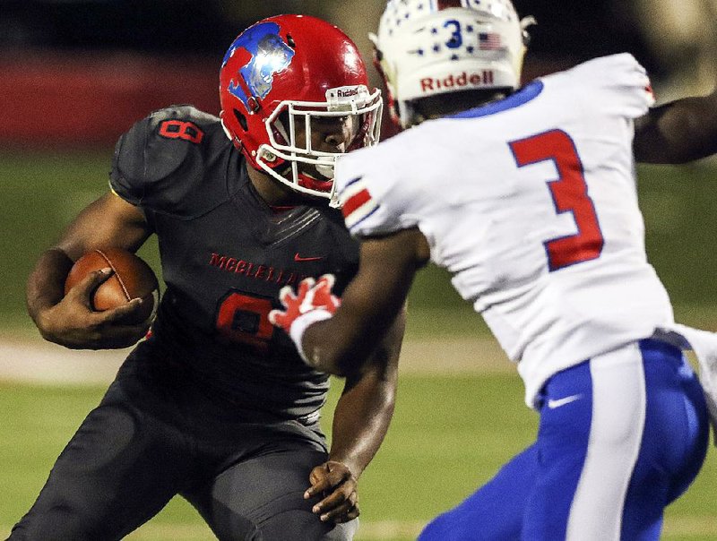 Little Rock McClellan quarterback Bennie Kemp tries to find an opening as Little Rock Parkview safety Geary Allmon (3) closes in during Thursday night’s game at War Memorial Stadium in Little Rock. 
