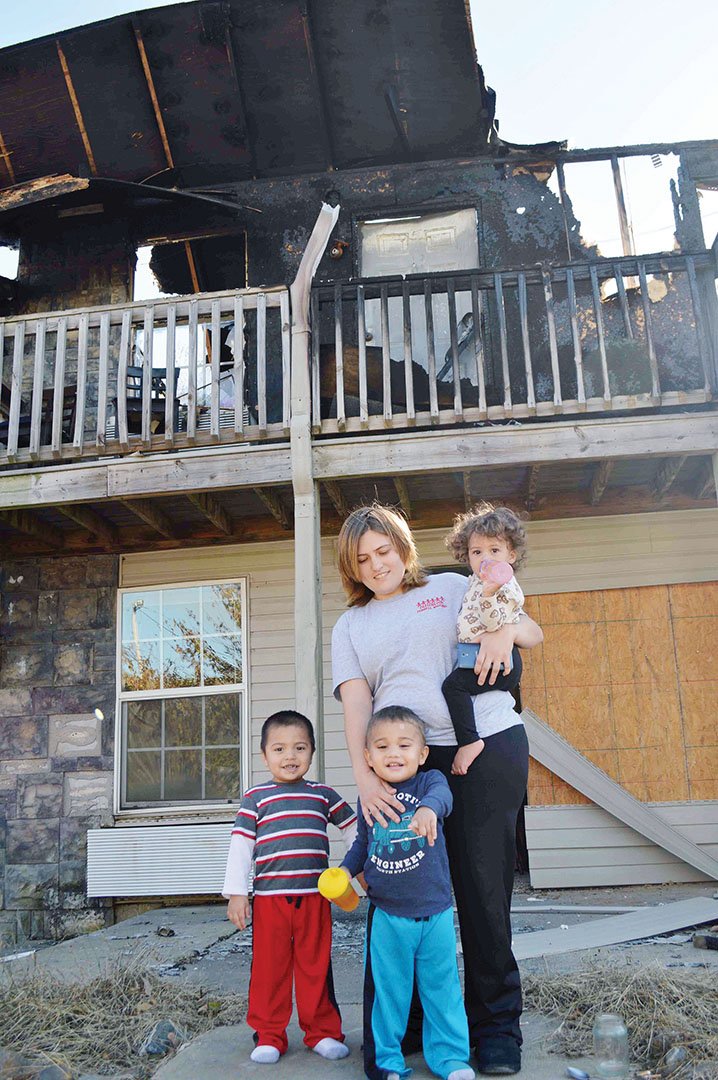 Monica Fortune stands in front of the charred remains of her Queens Manor Apartment unit in 
Mayflower with her three children, Dahlia, 1; Axton, 3; left, and Keanthony, 2. Fortune was at work Oct. 14 
when the fire started, which was determined to be arson. The children’s father was taking care of them, and they and all the other residents escaped without injury.
