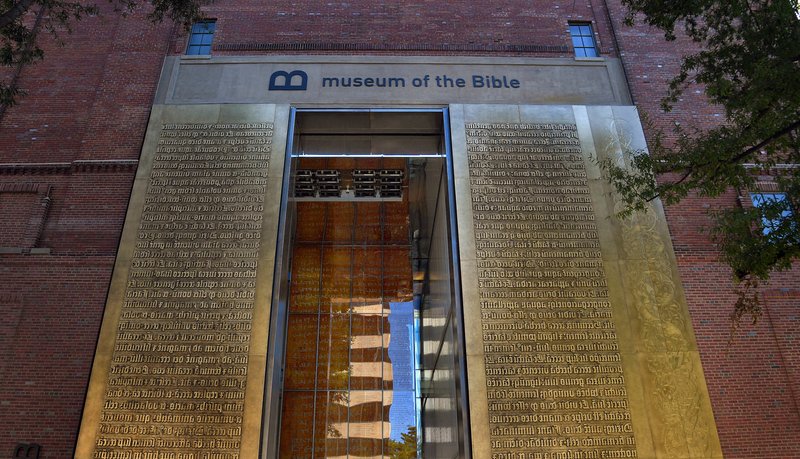 The Washington Post/MICHAEL S. WILLIAMSON The entrance to the Museum of the Bible features relief metal lettering of scriptures in Latin.