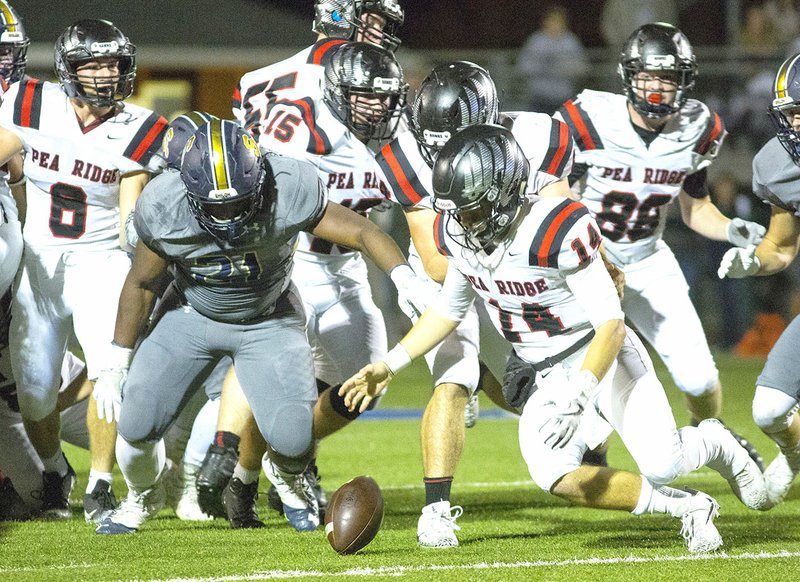 Special to NWA Democrat-Gazette/DAVID BEACH Pea Ridge quarterback Jakota Sainsbury (14) tries to recover his own fumble Friday as Shiloh Christian's Russell Norsworthy (21) also goes for the ball at Champions Stadium in Springdale.