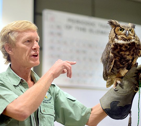 Submitted photo BOGART REHAB: Rodney Paul, owner and director of the Raptor Rehab of Central Arkansas, displayed Bogart the great horned owl Friday during National Park College's First Friday Lecture Series in the Laboratory Science Building. Paul and volunteer Tina Miller were accompanied by five birds from the facility in El Paso in White County.