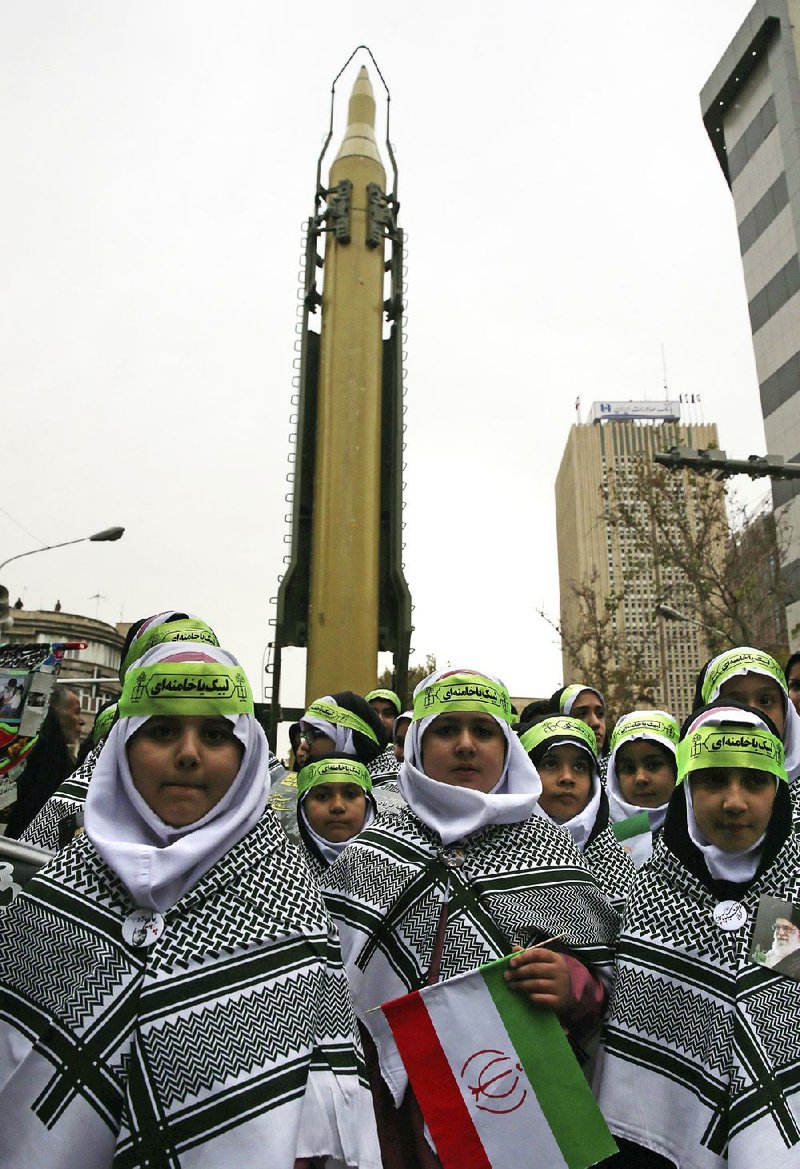 A surface-to-air missile looms over Iranian children Saturday outside the former U.S. Embassy in Tehran during an annual celebration of the 1979 takeover of the embassy by revolutionary forces.