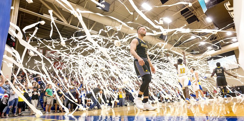 Courtesy photo Toilet paper flies across the court of Bill George Arena on Saturday at John Brown University in Siloam Springs.