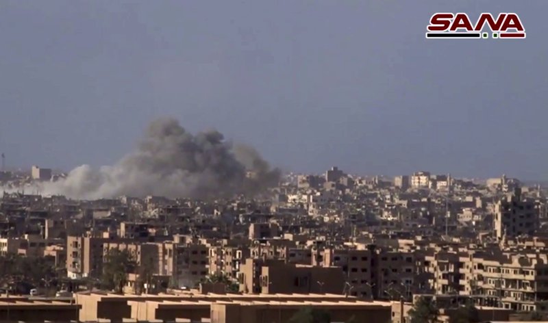 This frame grab from a video released on Nov. 2, 2017 by the Syrian official news agency SANA shows smoke and debris rising after Syrian government shelling of the Deir el-Zour city during a battle against Islamic State militants, Syria. The Syrian army announced on Friday, Nov. 3 it liberated the long-contested eastern city of Deir el-Zour from the Islamic State group. 
