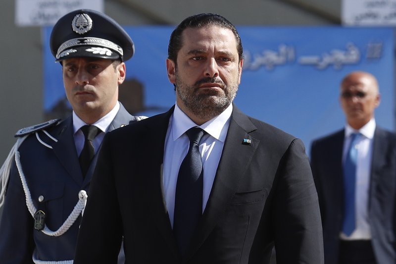 The Associated Press LEBANON: In this photo taken on Sept. 8, Lebanese Prime Minister Saad Hariri, left, arrives for a mass funeral of ten Lebanese soldiers at the Lebanese Defense Ministry, in Yarzeh near Beirut, Lebanon. Lebanese prime minister Saad Hariri has announced he is resigning in a surprise move following a trip to Saudi Arabia. In a televised address Saturday he slammed Iran and the Lebanese Hezbollah group for meddling in Arab affairs and says "Iran's arms in the region will be cut off."