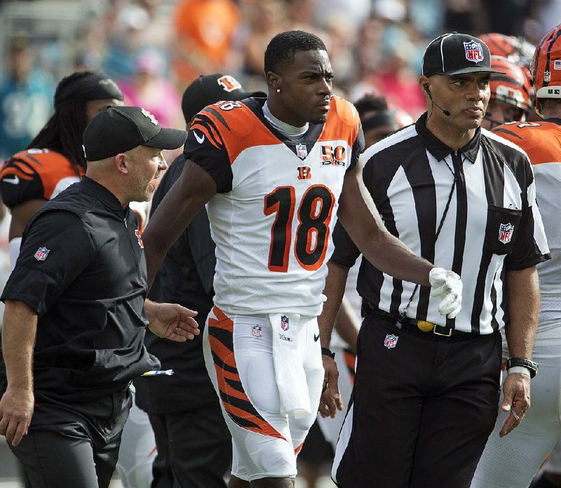 Cincinnati Bengals wide receiver A.J. Green (18) is escorted off the field after he was involved in an altercation with players from the Jacksonville Jaguars during the first half of an NFL football game, Sunday, Nov. 5, 2017, in Jacksonville, Fla. 