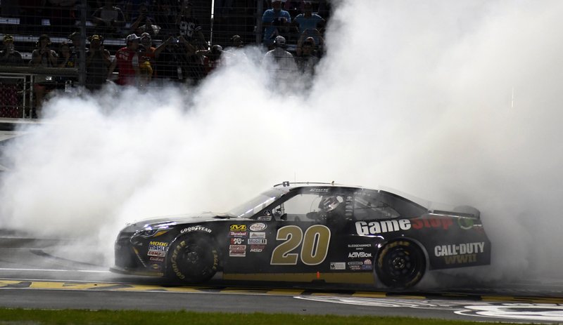 Erik Jones (20) does a burnout after winning a NASCAR Xfinity Series auto race at Texas Motor Speedway in Fort Worth, Texas, Saturday, Nov. 4, 2017. (AP Photo/Larry Papke)