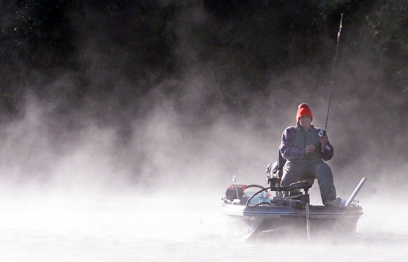 L.D. “Abby” Abbiatti of Fayetteville fishes on a cloud of steam rising off of Lake Fayetteville on Oct. 9, 2000. Abbiatti, who passed away in August, will have the boat ramp at the lake named after him.