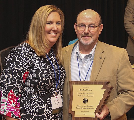 Submitted photo ACHIEVEMENT AWARD: Don Garner, right, who received the Louise Pope Lifetime Achievement Award, poses with with Brandy Owen, clinical pharmacist at Baptist Health Medical Center-Conway, who is the current president of the Arkansas Association of Health System Pharmacists.