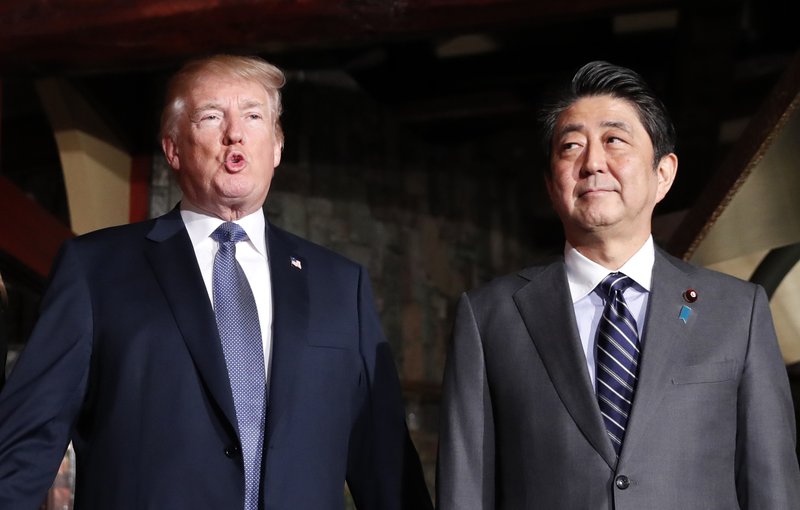 The Associated Press TRUMP: U.S. President Donald Trump, accompanied by Japanese Prime Minister Shinzo Abe, speaks to members of the media before having a dinner at Ginza Ukai Tei restaurant on Sunday in Tokyo. Trump is on a five-country trip through Asia traveling to Japan, South Korea, China, Vietnam and the Philippines.