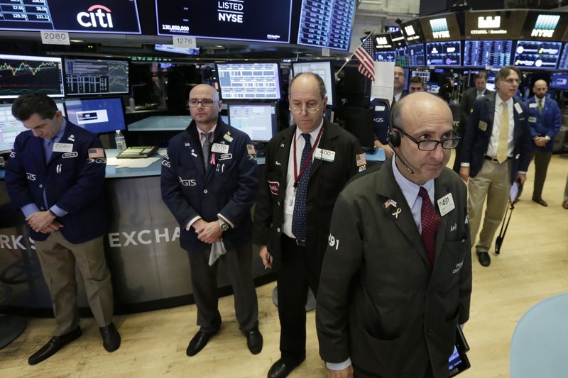 Traders observe a moment of silence for the victims of the shooting in Sutherland Springs, Texas, before the start of trading at the New York Stock Exchange on Monday. (AP Photo/Richard Drew)