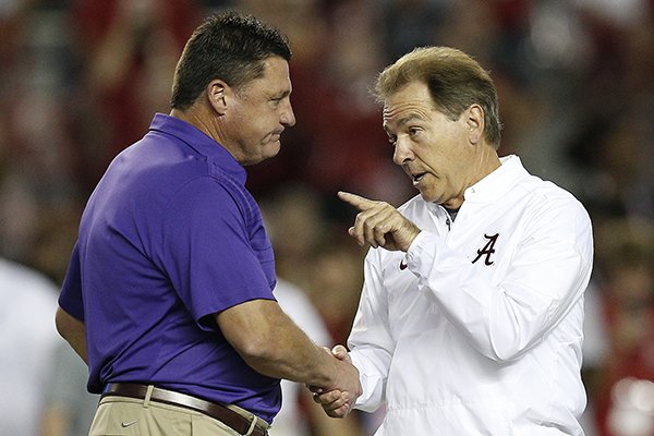 Alabama head coach Nick Saban, right, and LSU head coach Ed Orgeron, left, meet in the center of the field before an NCAA college football game, Saturday, Nov. 4, 2017, in Tuscaloosa, Ala. (AP Photo/Brynn Anderson)

